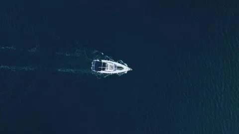 Top-down view of a sailing yacht in the center of the frame, sailing in the sea Stock Footage 228196489