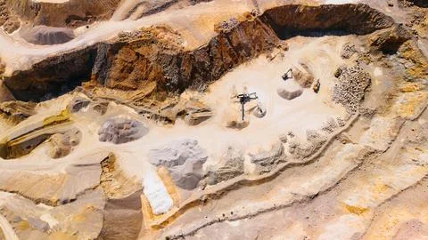 Top down view of sand pit floor with excavators and sand piles. Heavy machi.. Stock Photos