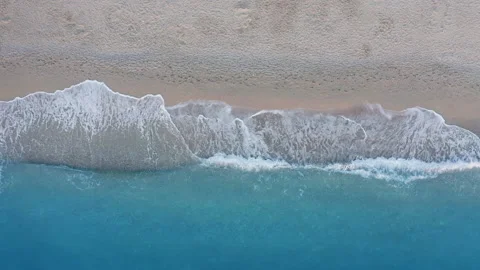 Top down view of sandy beach and turquoise sea waves at shore edge. Summer Video stock 144785958
