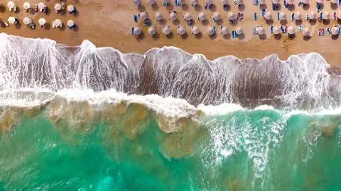 Top down view of the sea, sandy beach, sun umbrellas and sunbeds. Crete, Greece. Stock Footage 210859523