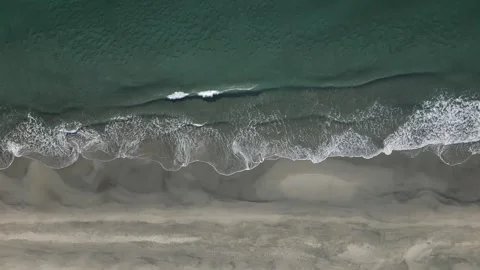Top down view of sea waves crashing on the shore, Aichi, Japan Stock Footage 325832869