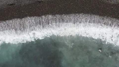 Top down view of sea waves on dark pebble beach Stock Footage 336023050