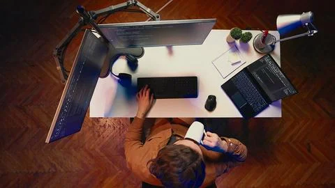 Top down view of self employed man doing IT support job, drinking coffee Stock Photos