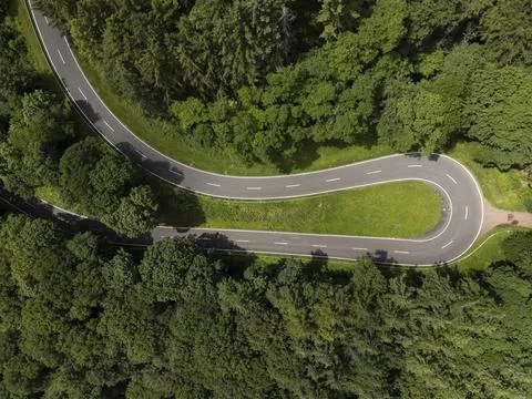 Top Down View of Sharp Hairpin Curve in German Forest Stock Photos