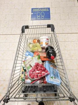 Top down view of shopping cart filled with various groceries stopped at safe  Stock Photos