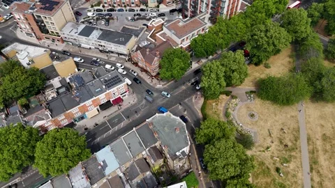 Top down view of a shopping parade, side streets and a parched open green in a Video stock 343471798