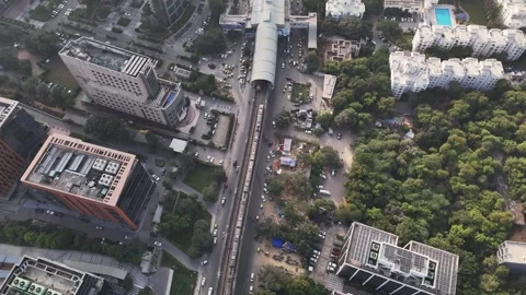 A top-down view showcasing dense green cover, white residential complexes, and Видео 323783622