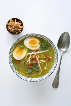 Top down view of a single bowl of Soto Ayam (Indonesian chicken soup) 写真素材