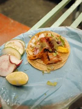 Top down view of a single Mexican al pastor street taco with cilantro, onio.. Stock Photos