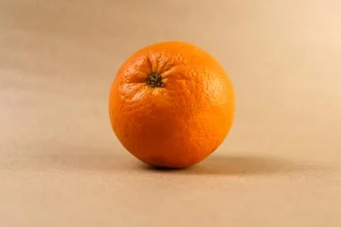 A top-down view of a single ripe orange fruit meticulously centered within Stock Photos