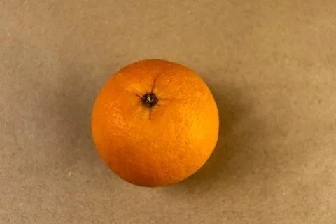 A top-down view of a single ripe orange fruit meticulously centered Stock Photos