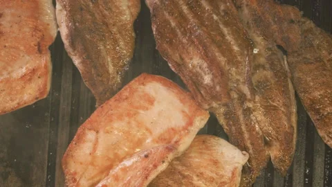 Top-Down View of Sizzling Chicken Cooking on a Flat Top Grill Stock Footage 301076312