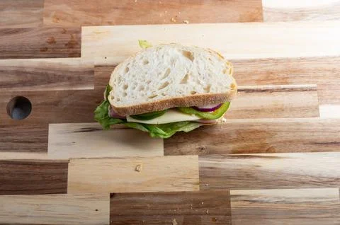 Top-down view of sliced bread on wooden background  rustic food scene Stock Photos