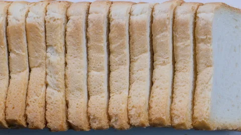 Top down view. Sliced toast bread arranged in a stack. Slider shot. Stock Footage 296559864