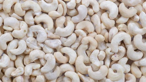 Top down view, slider shot of fresh cashew nuts in a heap. Video stock 296521094