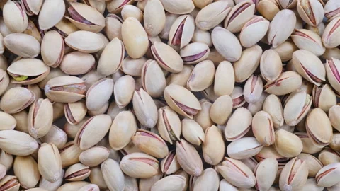 Top down view, slider shot of fresh pistachio nuts in a heap. Stock Footage 296521388