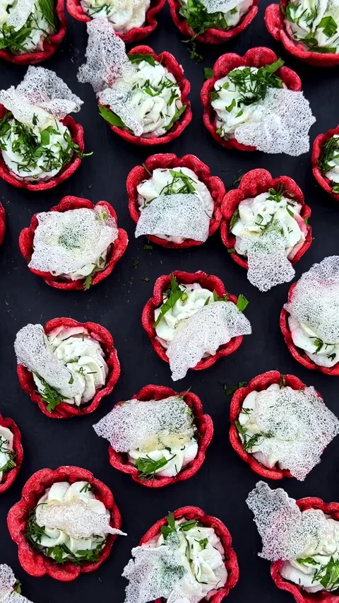 Top down view slowly approaching bite sized red tartlet shells filled with Stock Footage 348794196