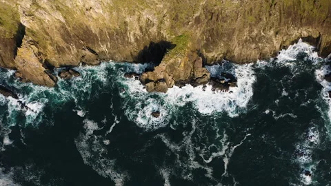 Top down view slowly pulling away from rugged Oregon Coast along Pacific Stock Footage 268802391
