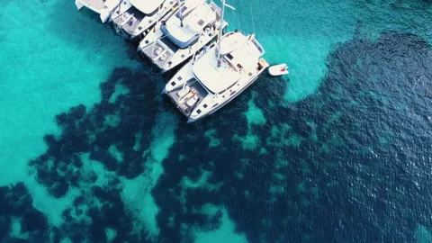 Top down view of small boats on crystal clear translucent blue water. Stock Footage 151509727