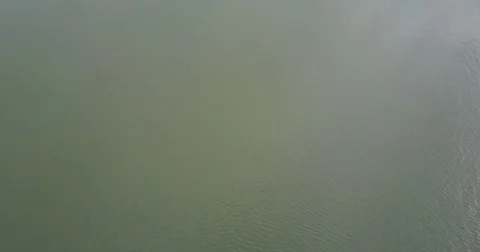 Top down view of a small cargo ship passing by Stock Footage 72573221