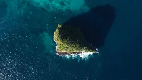 Top down view on small island in azure ocean Stock Footage 163366436