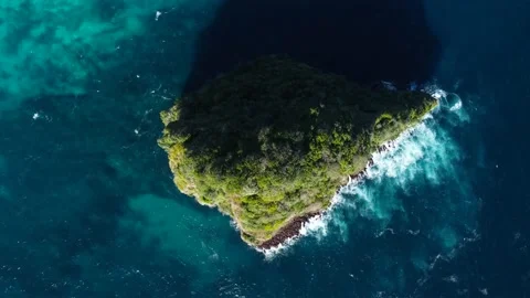 Top down view on small island in azure ocean Stock Footage 165844074