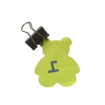 A top-down view of a small, light green paper cutout shaped like a teddy be.. Stockillustratie