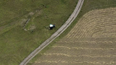 Top down view of small tractor moving along agriculture field Vídeo Stock 246712407