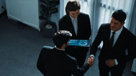 Top down view of smart manager standing with team and analyze data. Directorate. Foto stock