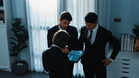 Top down view of smart manager standing with team and analyze data. Directorate. Foto stock