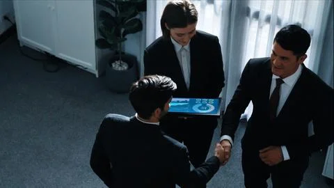 Top down view of smart manager standing with team and analyze data. Directorate. Foto stock