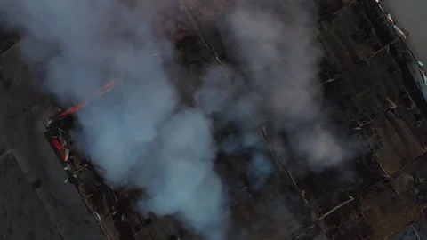 Top down view of smoke clouds from burnt warehouse building with burned roof Stock Footage 107165840