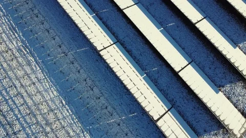 Top down view of a snow covered photovoltaic system. Snow covered solar panels. Stock Footage 145980298