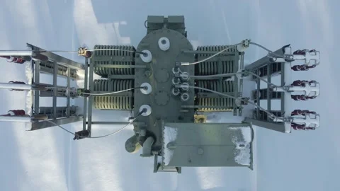 Top Down View of Snow Covered Power Transformer Aerial Video stock 328480262