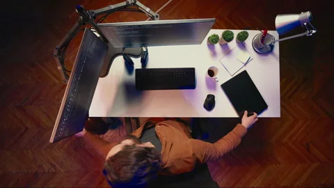 Top down view of software programmer finishing remote job shift packing backpack Stock Footage 265346522