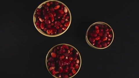 Top down view of spinning fresh wild strawberries Stock Footage 339418018