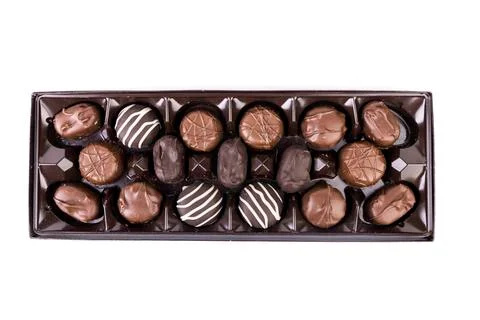 Top down view of square box of milk and dark striped chocolates in a shiny br Stock Photos