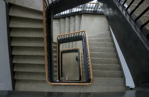 Top down view of a square spiral staircase with terrazzo steps. Stock Photos