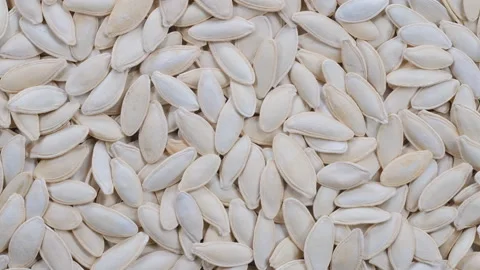 Top down view. Stack of pumpkin seeds with shell. Slider shot. Видео 296521629