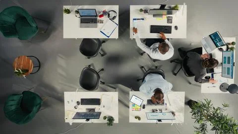 Top down view of staff consulting on project reports and data in office Stock Photos