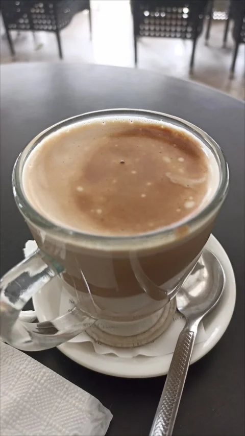 Top-down view of steaming hot coffee cup on a cafe table Stock Footage 334606940
