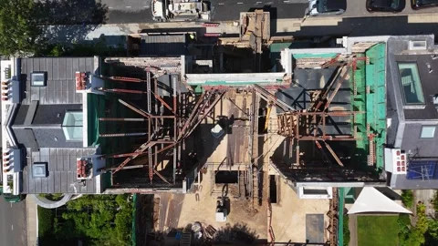 Top down view of steel props and shoring bracing the open shell of a prime Stock Footage 343476103