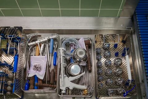 A top-down view of sterilized surgical instruments neatly arranged in metal.. Stock Photos