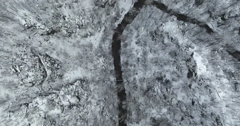 Top down view of stream in snowy winter forest in Wałbrzych Poland Stock Footage 346649328