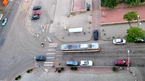 Top down view street paved street public transport stop stopped moving tram Stock Footage 326850146
