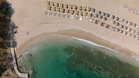 Top Down View Stunning Beach, Parasol, Clear Blue Water Lapping onto Sandy Stock Footage 99508843