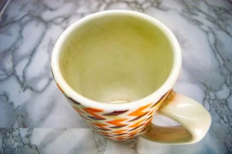 A top down view of a stylish white ceramic mug with a retro geometric patte.. 스톡 사진