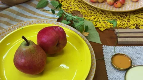 Top-down view of a summer table setting in progress. Bright yellow tableware and 動画素材 311847078