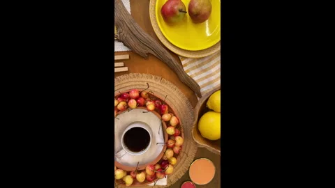 Top-down view of a summer table setting in progress. Bright yellow tableware and 動画素材 311850326