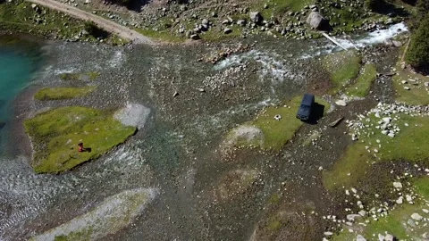 Top Down View Of SUV Crossing River Delta. Kyrgyzstan, Suttuu-Bulak Lake. Stock Footage 332787360